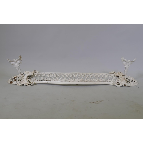 1019 - A Victorian painted serpentine shaped cast iron fire surround, with pierced decoration, 125 x 25cm h... 