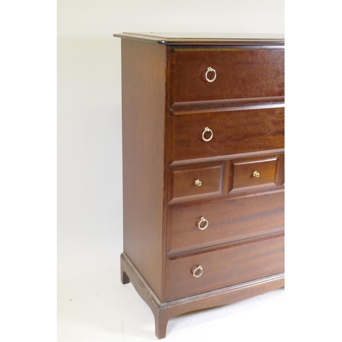 1021 - A Stag Minstrel tallboy chest of seven drawers, raised on square supports, 83 x 47 x 113cm