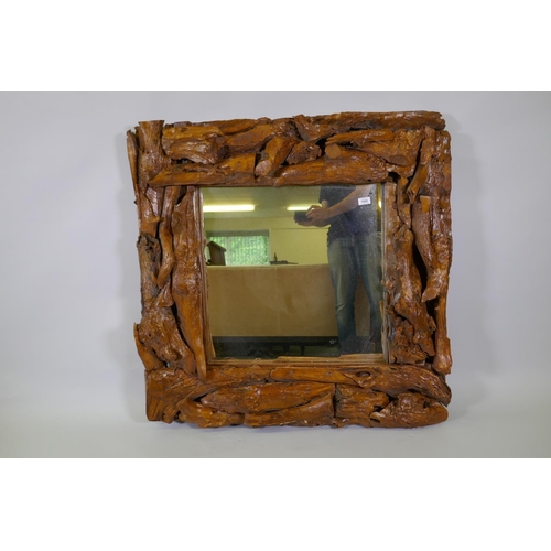 1026 - A varnished driftwood frame wall mirror, 104 x 104cm