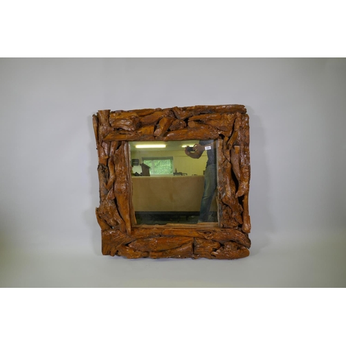 1026 - A varnished driftwood frame wall mirror, 104 x 104cm