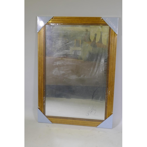 1029 - A contemporary gilt framed wall mirror with bevelled glass in original packing, 105 x 75cm