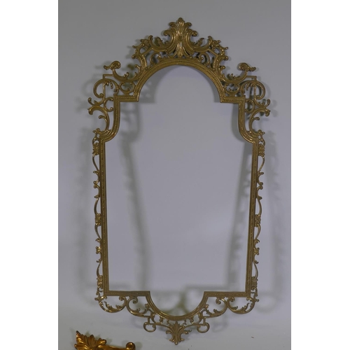 1030 - A pierced brass mirror frame, 90 x 47cm, and an Italian gilt wall mirror