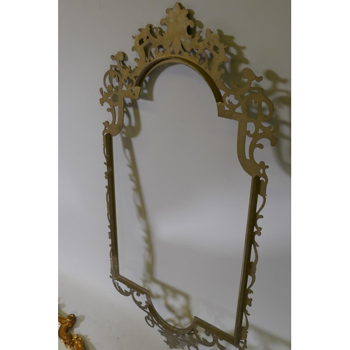 1030 - A pierced brass mirror frame, 90 x 47cm, and an Italian gilt wall mirror