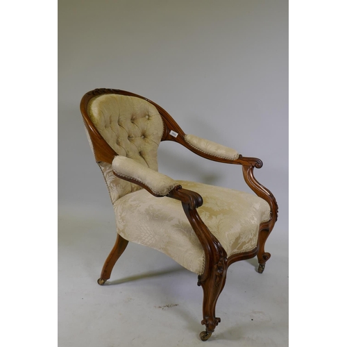 1033 - A Victorian faded rosewood open arm easy chair with carved decoration and serpentine shaped front, r... 