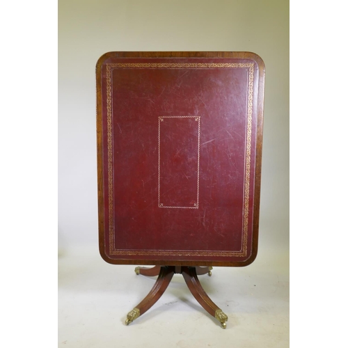 1034 - A Regency mahogany tilt top library/centre table with gilt tooled leather inset top, raised on turne... 