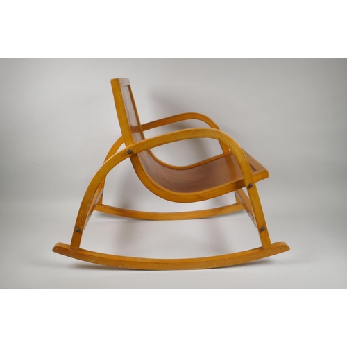 1036 - A mid century Bauhaus style child's birch bentwood rocking chair, 56cm long