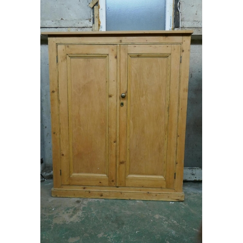 1039 - Victorian stripped pine two door cupboard, raised on a plinth base, 100 x 34 x 117cm