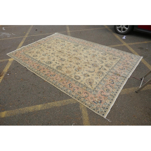 1040 - A cream ground Isfahan carpet with an all over floral design and blue borders, 180 x 240cm