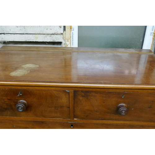 1041 - A Victorian mahogany chest of two over three drawers with original turned wood handles, raised on tu... 