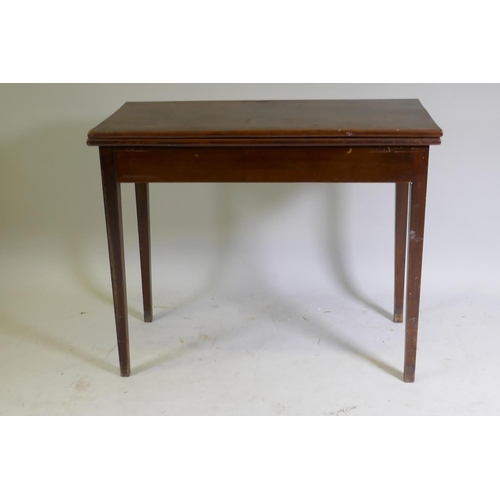 1044 - A C19th mahogany tea table with fold over top, raised on square tapering supports, 89 x 45 x 73cm