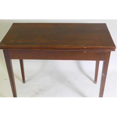 1044 - A C19th mahogany tea table with fold over top, raised on square tapering supports, 89 x 45 x 73cm