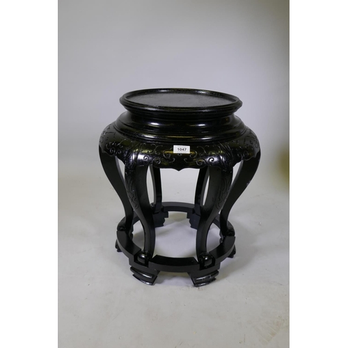 1047 - A Chinese carved and painted hardwood vase stand, 53cm high, 45cm diameter