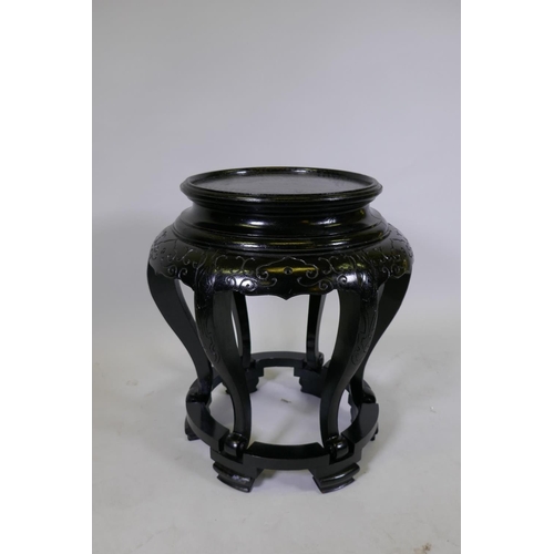 1047 - A Chinese carved and painted hardwood vase stand, 53cm high, 45cm diameter