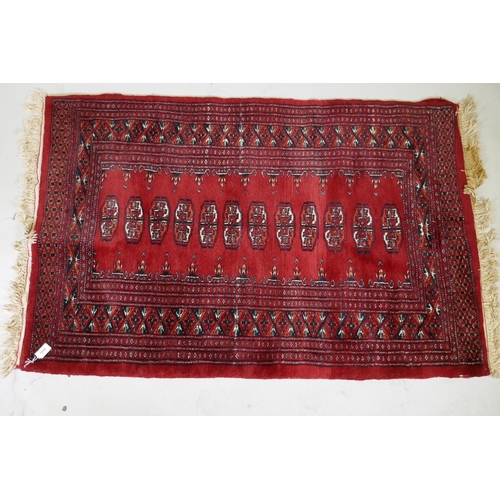 1049 - A Bokhara wool rug with traditional design, 145 x 91cm