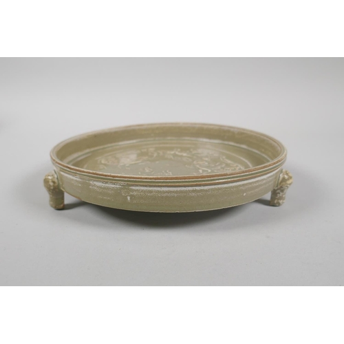 105 - A Chinese Song style olive glazed dish raised on tripod supports, with raised phoenix and kylin deco... 