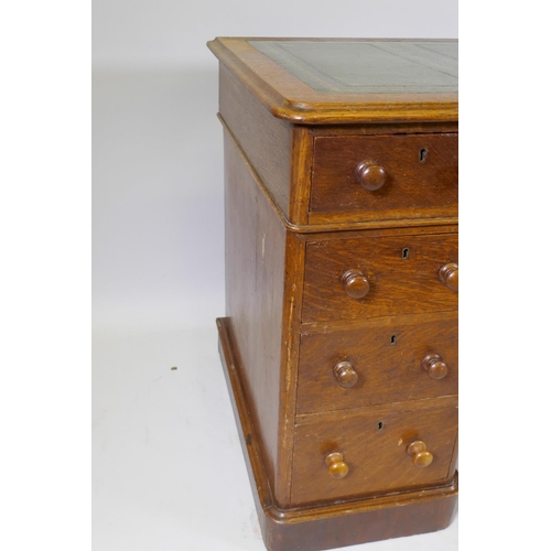 1052 - Victorian oak veneered nine drawer pedestal desk with gilt tooled leather inset top, 122 x 60 x 72cm