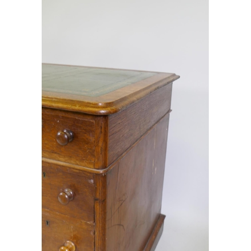 1052 - Victorian oak veneered nine drawer pedestal desk with gilt tooled leather inset top, 122 x 60 x 72cm