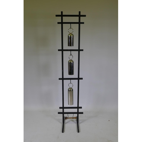 1053 - A graduated set of chromed metal gongs on a stand, 153cm high