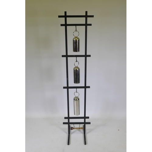 1053 - A graduated set of chromed metal gongs on a stand, 153cm high