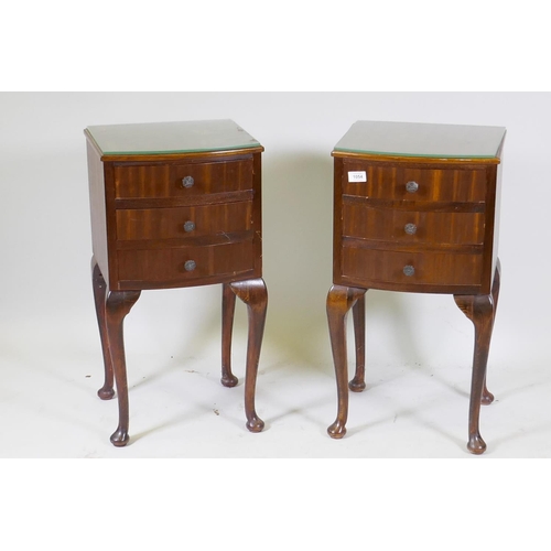 1054 - A pair of bowfront mahogany bedside chests with three drawers, raised on cabriole supports, 32cm dee... 