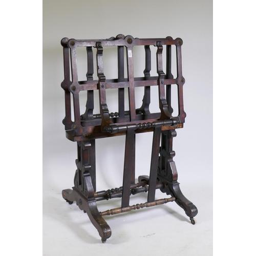 1058 - A beechwood folio stand, with carved and pierced end supports united by turned stretchers, and brass... 