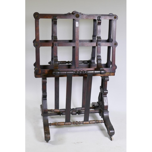 1058 - A beechwood folio stand, with carved and pierced end supports united by turned stretchers, and brass... 