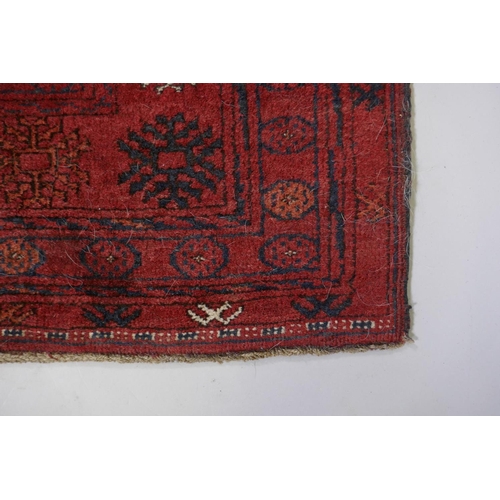 1075 - A Turkish red ground wool Bokhara rug, 102 x 190cm