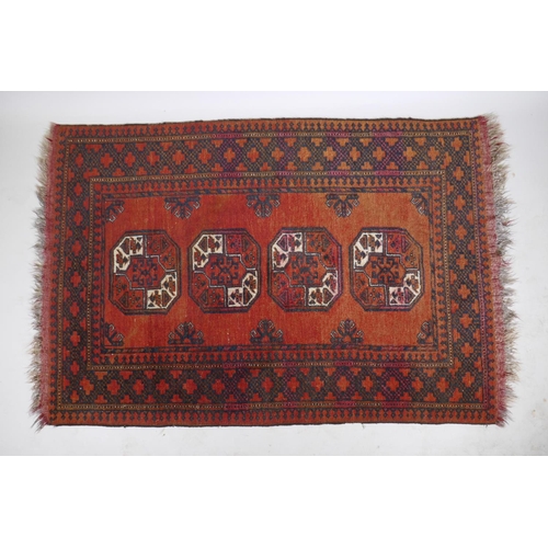 1076 - A Turkish deep red ground wool rug with a Bokhara style design, 110 x 165cm