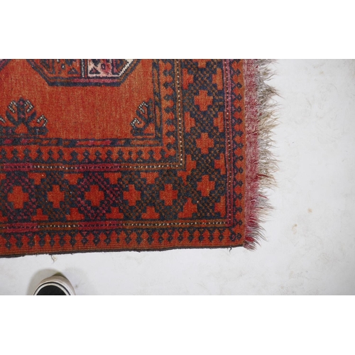 1076 - A Turkish deep red ground wool rug with a Bokhara style design, 110 x 165cm