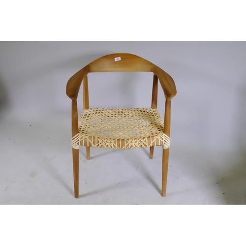 1080 - A Scandinavian style beechwood armchair with leather strapped seat after Hans Wegner