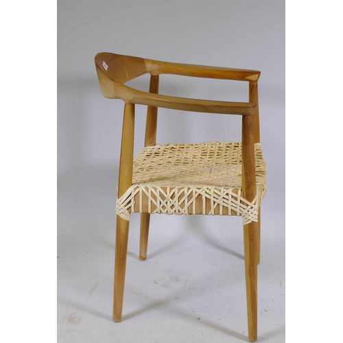 1080 - A Scandinavian style beechwood armchair with leather strapped seat after Hans Wegner