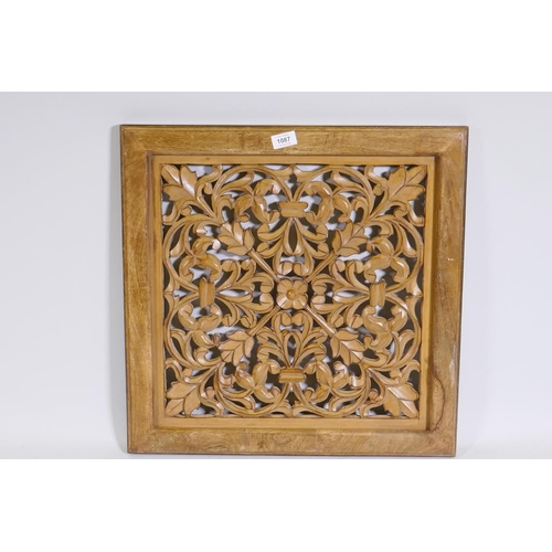 1087 - A fretwork panel with floral motifs in wood frame, 57 x 57cm