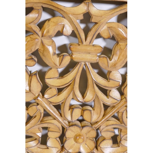 1087 - A fretwork panel with floral motifs in wood frame, 57 x 57cm