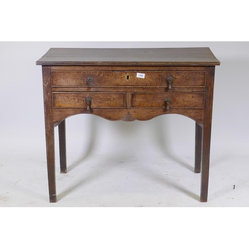 1090 - Early C19th oak side table, with single drawer over two more, shaped and carved apron and square sup... 