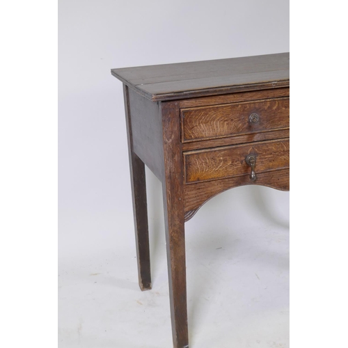 1090 - Early C19th oak side table, with single drawer over two more, shaped and carved apron and square sup... 