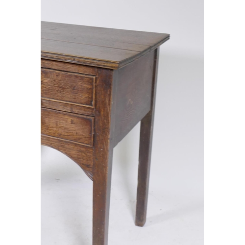 1090 - Early C19th oak side table, with single drawer over two more, shaped and carved apron and square sup... 