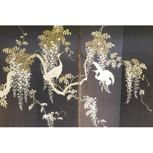 1095 - An oriental embroidered silk four fold screen in a lacquered wood frame, each panel 43 x 161cm