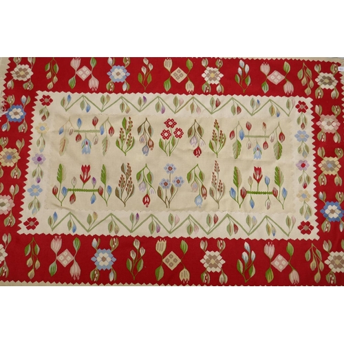 1100 - A vintage kilim rug with floral designs and a red border, signed, 195 x 122cm