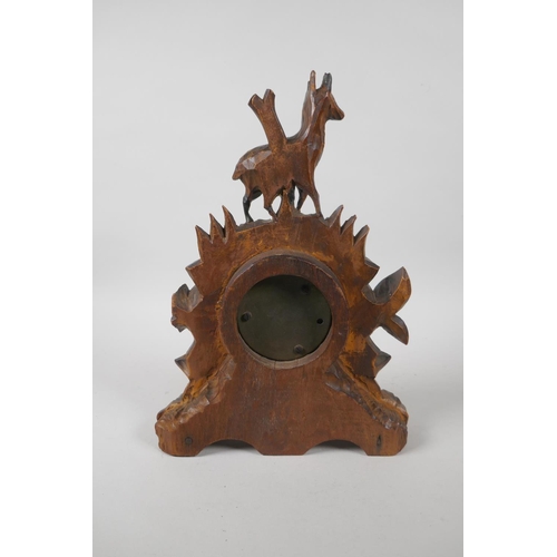 120 - A brass barometer in a carved Black Forest mount, decorated with a deer and leaves, 29cm high