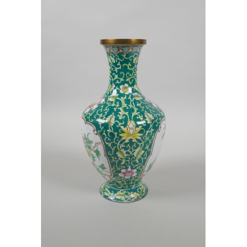 126 - A Chinese Canton enamel vase with decorative panels depicting birds, peaches and flowers, 20cm high