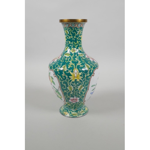 126 - A Chinese Canton enamel vase with decorative panels depicting birds, peaches and flowers, 20cm high