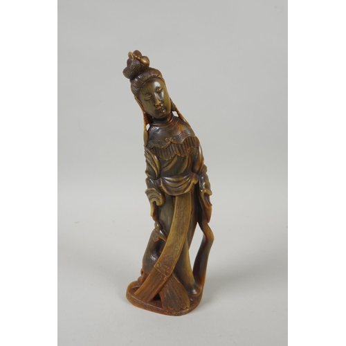 128 - An antique Chinese carved horn figure of Guan Yin, 21cm high