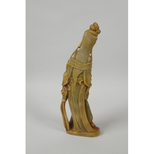 128 - An antique Chinese carved horn figure of Guan Yin, 21cm high