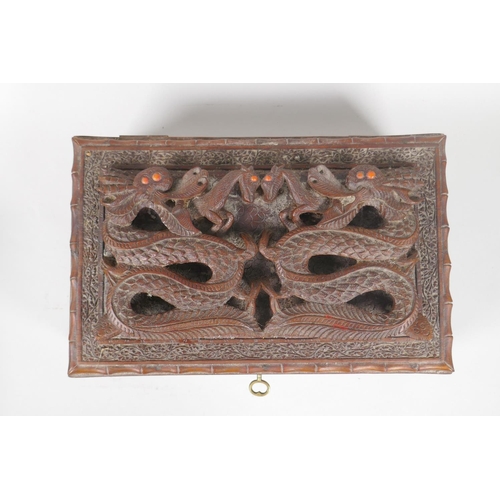 129 - An antique Burmese carved camphor wood jewellery box with entwined dragon decoration, and another sm... 