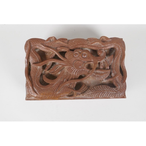 129 - An antique Burmese carved camphor wood jewellery box with entwined dragon decoration, and another sm... 