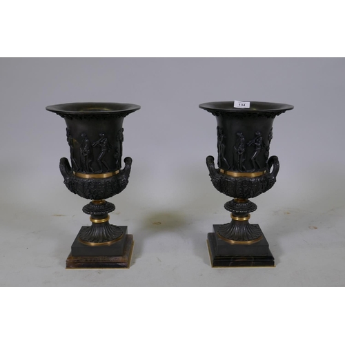 134 - A pair of Grand Tour style bronze urns with polished mounts and raised decoration, 37cm high