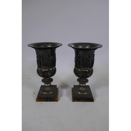 134 - A pair of Grand Tour style bronze urns with polished mounts and raised decoration, 37cm high