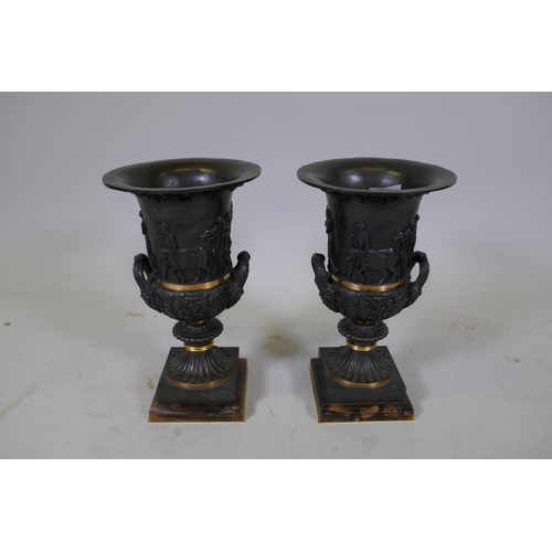 134 - A pair of Grand Tour style bronze urns with polished mounts and raised decoration, 37cm high