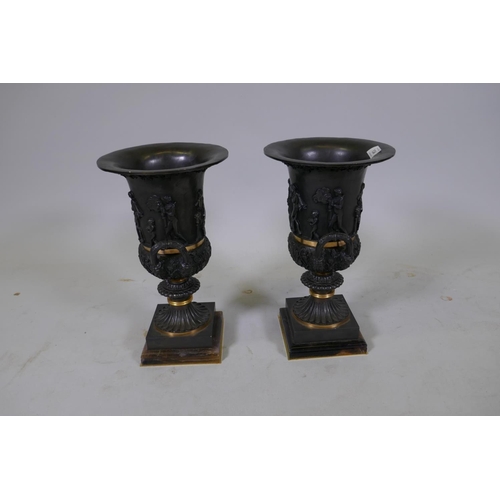 134 - A pair of Grand Tour style bronze urns with polished mounts and raised decoration, 37cm high