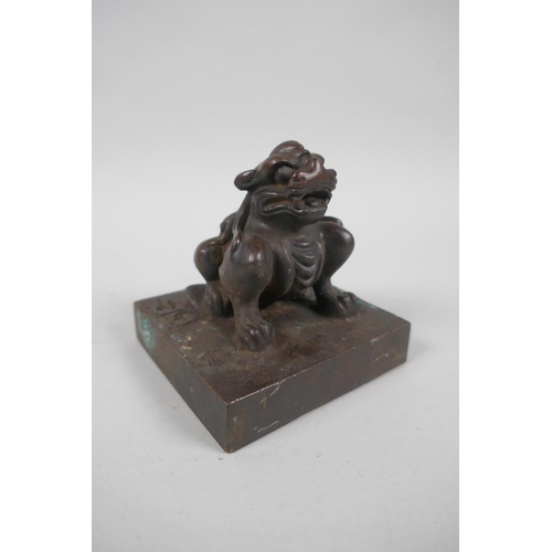 138 - A Chinese filled bronze seal with kylin knop, 8 x 8cm